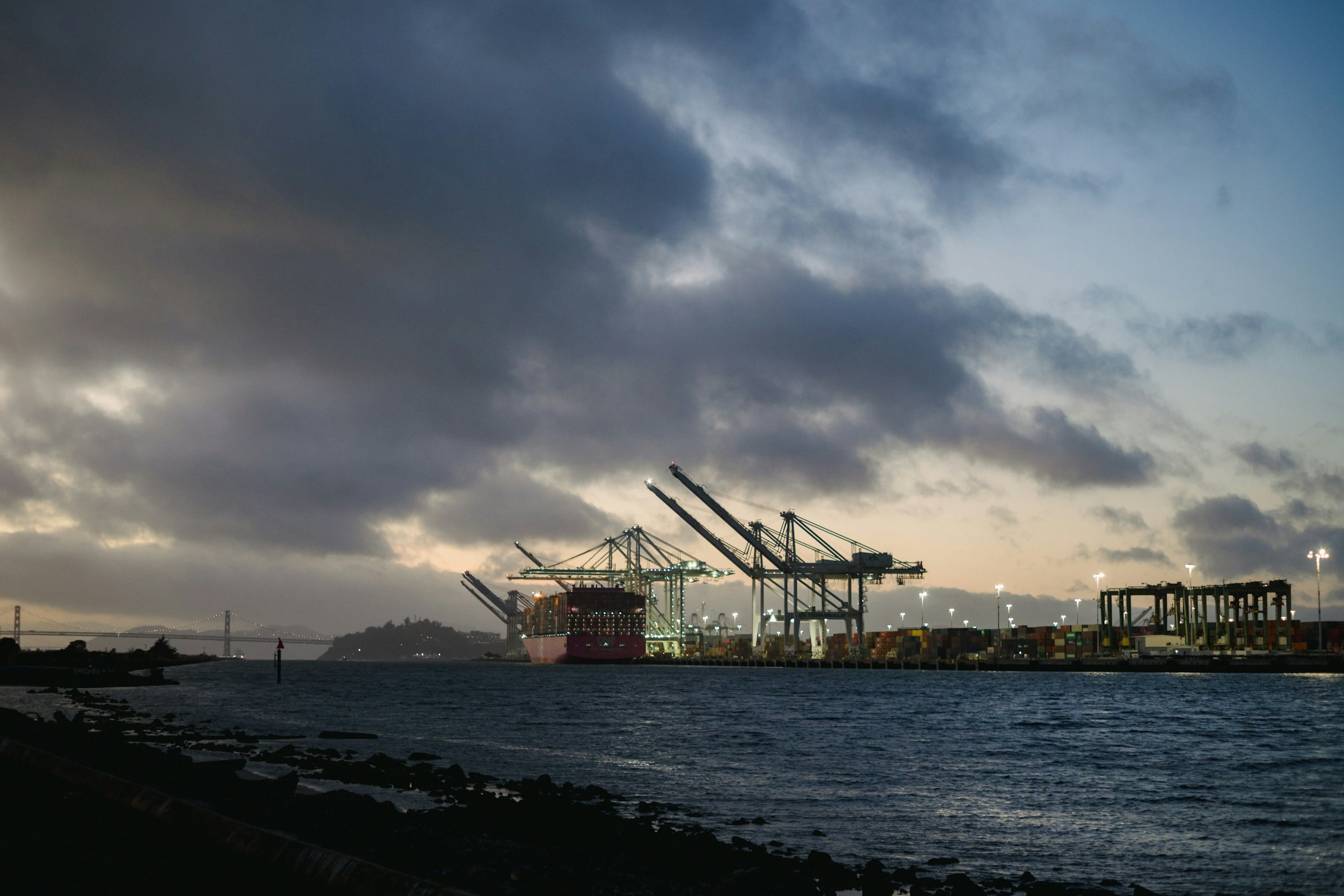 Container cranes at a port at dusk